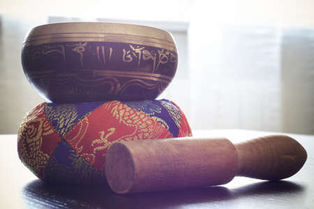 Closeup of a tibetan bell on a tableの写真素材
