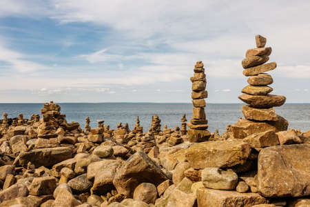 Several piles of balancing rocks at the seashoreの写真素材