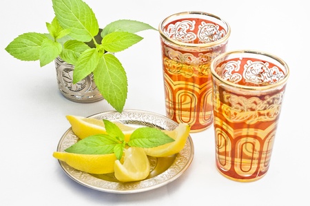 Two glasses of Moroccan tea with some slices of lemon and mint leavesの写真素材