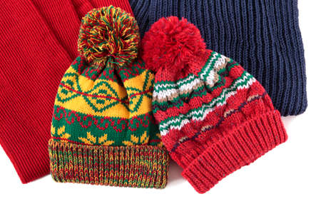 Two bobble hats and scarves isolated against a white background.の写真素材