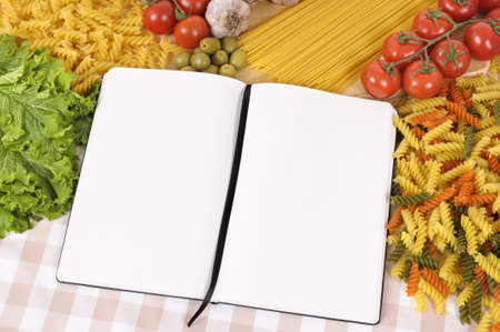 Selection of Italian spaghetti and pasta with blank recipe book or cookbook. Space for copy.の写真素材