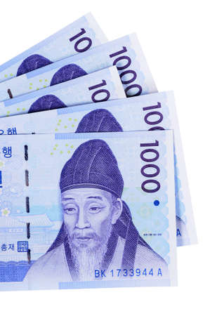 Several Korean 1000 Won currency bills isolated on a white background.の写真素材