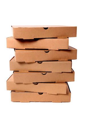 Untidy stack of plain brown pizza boxes isolated against a white background.の写真素材