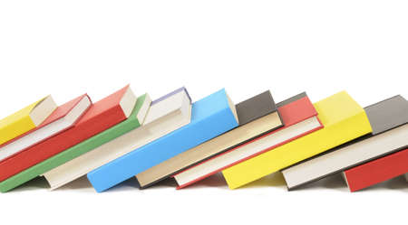 Leaning row of colorful books isolated against a white background.  Space for copy.の写真素材