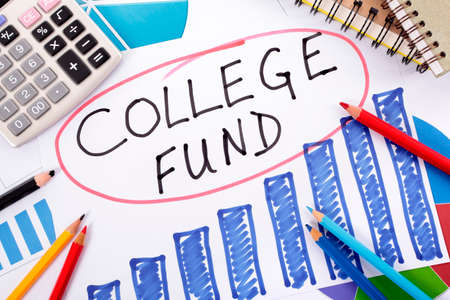 The words College Fund circled in red surrounded by graphs, calculator, books and pencils.の写真素材