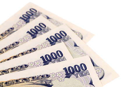 Several Japanese 1000 Yen currency bills isolated on a white background.の写真素材