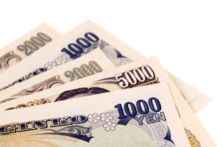 Selection of several different Japanese Yen currency bills isolated on a white background.の写真素材