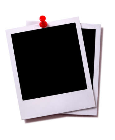 Two blank instant camera photo prints with red pushpin isolated on white with shadow.  Space for copy.の写真素材