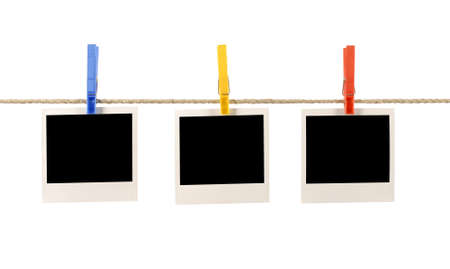 Blank instant photo prints hanging on a rope