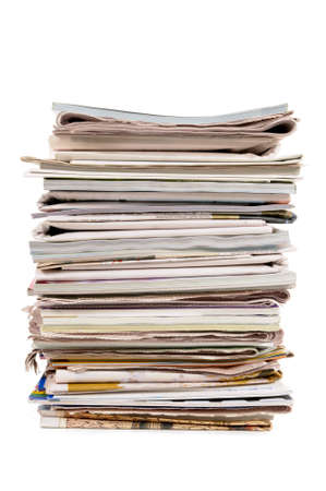 Stack of newspapers and magazines against a white backgroundの写真素材