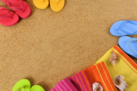 Beach background with towel and flip flops.  Space for copy.の写真素材