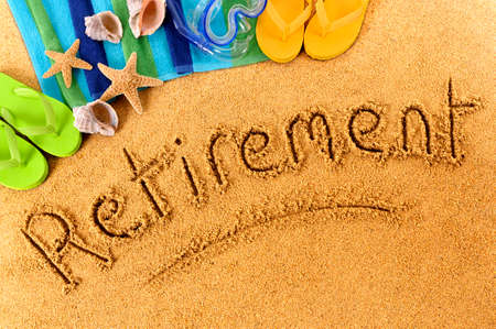 Beach background with towel and flip flops and the word Retirement written in sand.