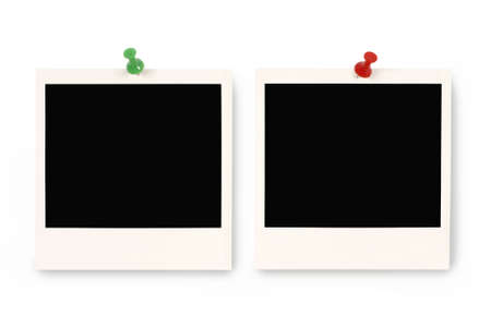 Two blank instant camera photo prints with blue and red pushpins isolated on a white background.  Space for copy.の写真素材