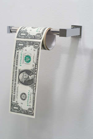 Dollar bills in the form of a roll of toilet paperの写真素材