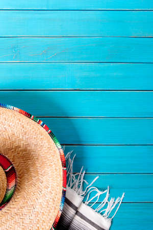 Mexican sombrero and traditional serape blanket laid on an old blue painted pine wood floor.  Space for copy.の写真素材