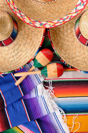 Mexican scene with sombrero straw hat, maracas and traditional serape blanket or rug.  Space for copy.の写真素材