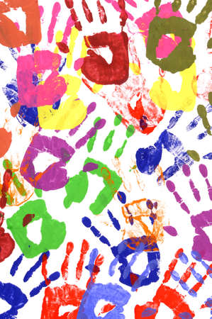 Messy or untidy pattern of child handprints made from vivid acrylic paint isolated on a white paper background.の写真素材