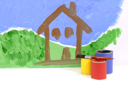 Home decorating concept with partly painted house scene on a white wall with paint cans and paintbrushes. Space for copy.の写真素材