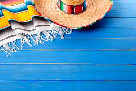 Mexican sombrero and traditional serape blanket laid on an old blue painted pine wood floor.  Space for copy.の写真素材