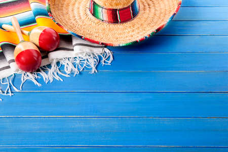 Mexican sombrero and maracas with traditional serape blanket laid on an old blue painted pine wood floor.  Space for copy.の写真素材