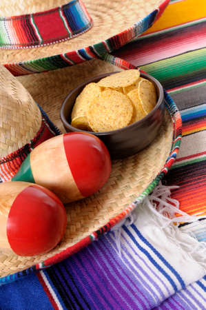 Mexican sombreros and traditional serape blankets with maracas and tortilla chips.の写真素材