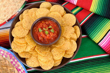 Mexican sombreros and traditional serape blankets with salsa dip and tortilla chips.の写真素材