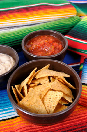 Mexican traditional serape blankets with salsa dip and tortilla chips.の写真素材