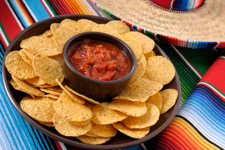 Mexican sombreros and traditional serape blankets with salsa dip and tortilla chips.の写真素材