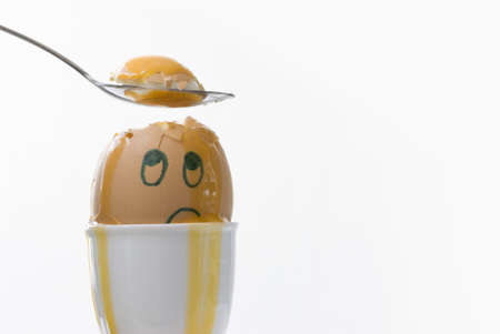 An unhappy, confused and dazed boiled egg.  Copy space on right.の写真素材
