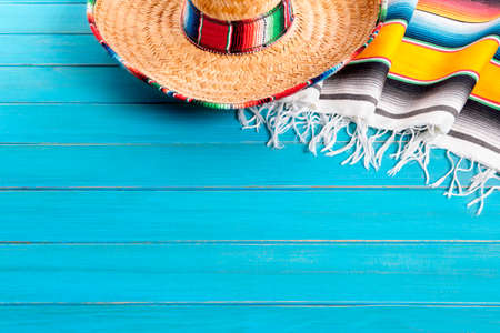 Mexican sombrero and traditional serape blanket laid on an old blue painted pine wood floor.  Space for copy.の写真素材