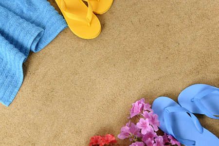 Beach background with towel, flowers and flip flopsの写真素材