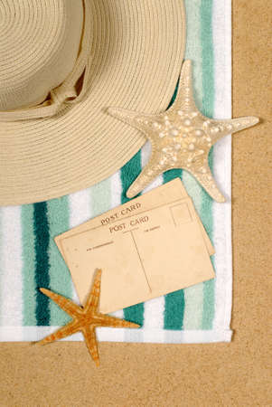 Seashore background with postcards shells beach towel and starfishの写真素材