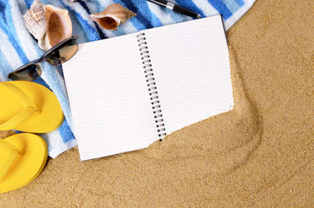 Beach background with towel, flip flops and blank notebook.の写真素材