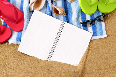 Beach background with towel, flip flops and blank notebook.の写真素材