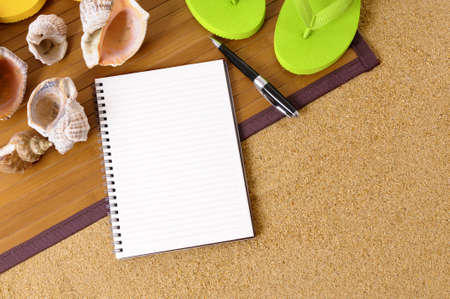 Beach background with bamboo mat, flip flops and blank notebook.の写真素材