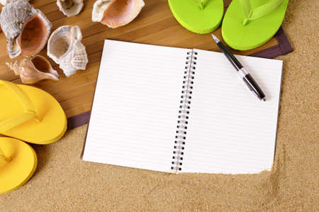 Beach background with bamboo mat, flip flops and blank notebookの写真素材