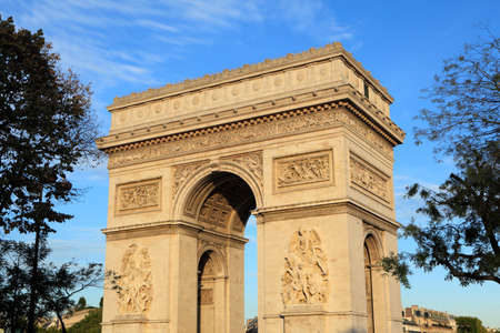 The majestic Arc de Triomphe in central Paris bathed in warm late afternoon light.の写真素材