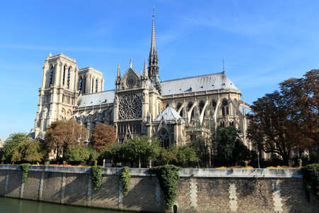 River Seine side view of the famous Notre Dame cathedral in Paris bathed in directional morning light.の写真素材