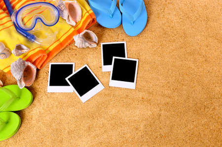 Beach background with blank photo prints, seashells, beach towel, flip flops and starfishの写真素材