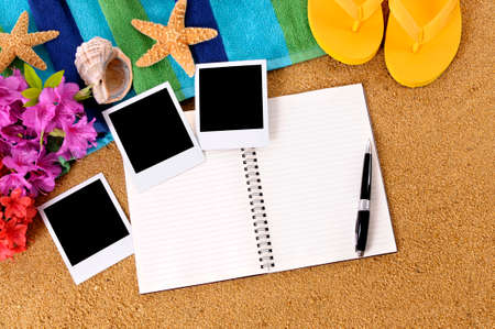 Hawaiian beach scene with writing book and blank photo prints, traditional flowers, beach towel, starfish and flip flopsの写真素材