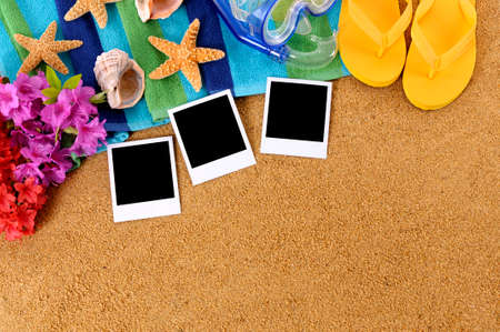 Hawaiian beach scene with blank photo prints, traditional flowers, beach towel, starfish, scuba mask and flip flopsの写真素材