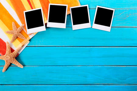Beach background with four blank instant photo prints, copy spaceの写真素材