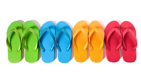 Row of colorful flip flops isolated against a white background.の写真素材