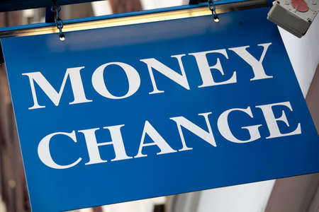 Money change sign above the entrance to a currency exchange office in London.の写真素材