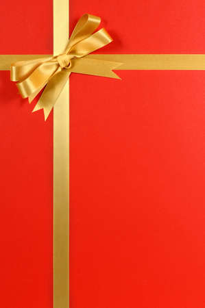 Christmas gift border frame with gold ribbon and bow verticalの写真素材