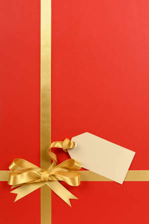 Red and gold gift with blank tag or label.の写真素材