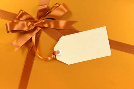 Gold christmas gift background ribbon and bow, gift tagの写真素材