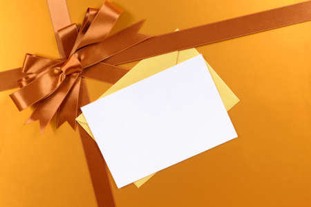 Gold christmas gift background ribbon and bow, gift tag or christmas cardの写真素材