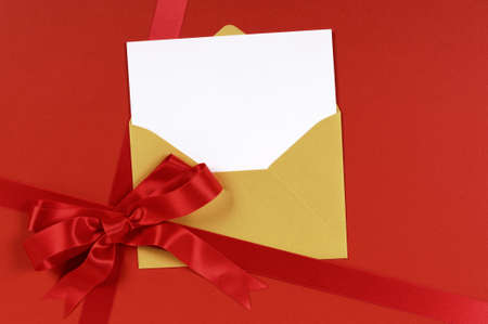 Red gift background with gold envelope and blank invitation or greetings card.の写真素材