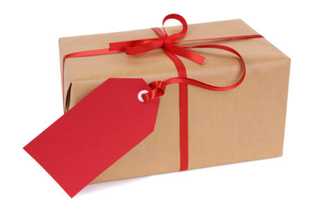 Brown paper package or gift tied with red ribbon and gift tag isolated on white backgroundの写真素材